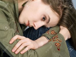 3120617-Portrait-of-sorrowful-girl-putting-head-on-knee-Stock-Photo